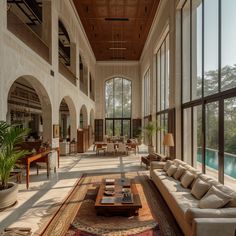 a large living room filled with furniture and windows