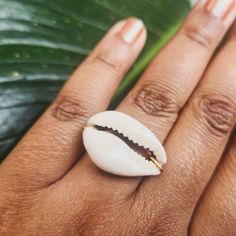 This simple, unadorned handmade unisex ring is made with natural genuine cowrie sea shells, and is available in sizes 0 through 13. The rings are available with 3 kinds of wire: 100% copper wire, gold-colored German wire, or stainless steel wire. These rings are wrapped by hand, meaning each ring is unique, but done in the same style.  Throughout Africa and the Americas, cowrie shells have historically been viewed as symbols of womanhood, fertility, and prosperity.  Please choose your ring size Summer Beach Jewelry Ring, Beach Summer Jewelry Ring, Handmade White Shell Rings, Ocean-inspired Shell Rings For Beach, White Shell-shaped Rings For Beach, Gold Shell Rings For Beach, Handmade Shell Ring For Beach, White Beach Ring Jewelry, White Shell Rings For The Beach