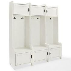 three white wooden lockers sitting next to each other