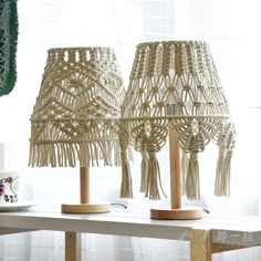 two lamps made out of rope sit on a table