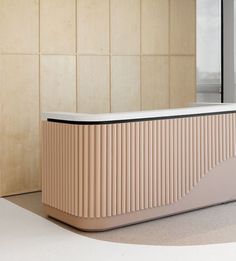 an empty counter in front of a wall with wood paneling and a window behind it