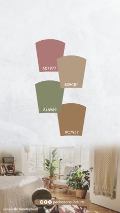 a living room filled with furniture and lots of color swatches on the wall above it