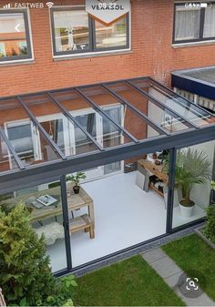 an overhead view of a modern house with glass walls and sliding doors on the outside