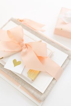 a pink bow on top of some cards