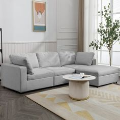 a living room with a sectional couch and coffee table