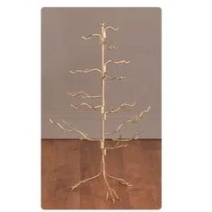 a white metal tree on a wooden floor