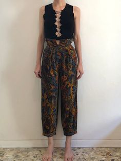 Wonderful 1980s Kenzo harem pants.  I think probably based on traditional Japanese trousers. These are so good.  First the fabric - a super fine corduroy with a velvet touch.  The pants have four pleats on each side in the front. The back has darts for shape.  High waist with a section that rises above the waist band - for a kind of paper bag waist band.  Four button exposed fly.  Side seam pockets! Pant leg is wide and full.  At the hem the leg is gathered into pleats and finishes with a cuffed band.  Wonderful psychedelic paisley floral pattern.  Label Kenzo Jungle, Paris. Made in France. Size 36.  Fabric is 100% cotton. Wash cool water, drip dry.  Great vintage condition with no fabric or sewing flaws.  Measurements Waist 65cm/ 25.5inches Hips 116cm/ 45inches Rise 31cm/ 12inches Waist t Japanese Trousers, Corduroy Pants Men, Paisley Pants, Full Midi Skirt, Vintage Woolrich, Womens Trousers, Cheerleading Outfits, 90s Streetwear, Corduroy Skirt