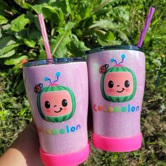 two pink tumblers with ladybugs on them and the words cocomelon painted on them