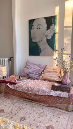 a living room filled with furniture and a painting on the wall above it's head