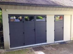 two garage doors are open in front of a house