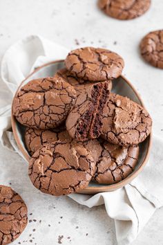 a plate full of chocolate cookies with one cut in half