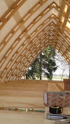 the inside of a wooden structure with tools and supplies on it's counter top