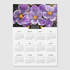 a calendar with purple flowers in the middle and one on it's front page