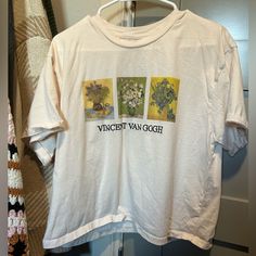 a white t - shirt with an image of three flowers on the front and back