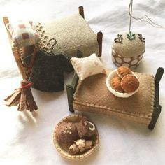 there are several small items on the table together, including a doll house bed and other things