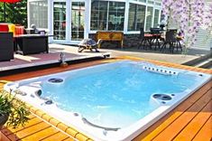 a hot tub sitting on top of a wooden deck