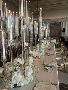 a long table is set up with candles and flowers for a formal dinner or reception