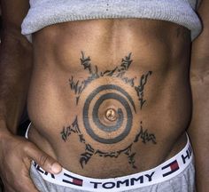 a close up of a person with tattoos on their stomach