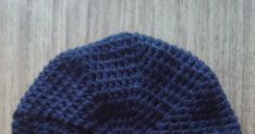 a blue knitted hat sitting on top of a wooden floor