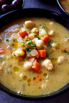 two bowls filled with soup on top of a table