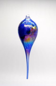 a blue glass vase hanging from a string