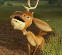 the antelope is standing in the grass and looking up at something with its mouth open