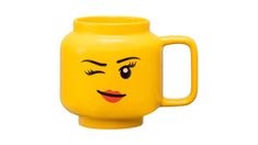 a yellow mug with a face drawn on it