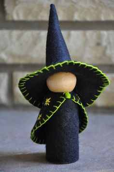 a small black hat with a wooden button on it