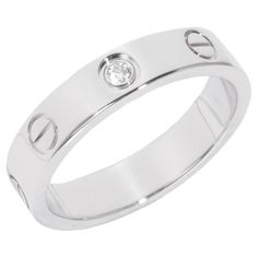 a white gold ring with two diamonds on the top and one diamond in the middle