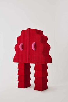 a red piece of art that looks like it is made out of cardboard