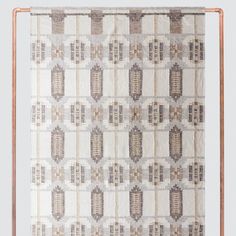 a white and brown patterned wall hanging