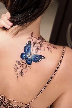 a woman with a blue butterfly tattoo on her back