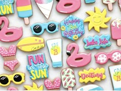 some decorated cookies are laying on a white surface with the words fun and sun written in them