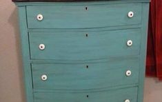 a blue dresser with white knobs on it