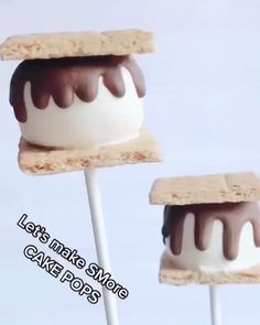 two marshmallows on top of each other with chocolate drizzled on them