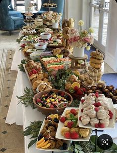 a table filled with lots of different types of food and desserts on top of it