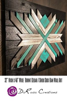 a wooden wall art with green and brown strips