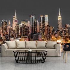 a living room filled with furniture next to a large cityscape wallpaper mural