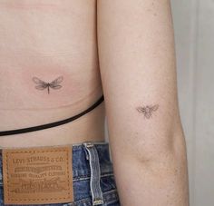 two small tattoos on the back of women's stomachs, one with a bee