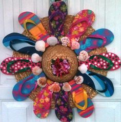 a wreath made out of flip flops and flowers on the front door with text that reads, pinterest