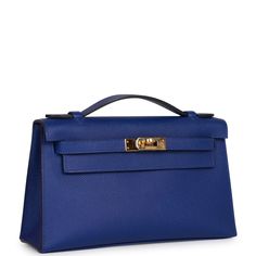 This rare Mini Kelly Pochette is in Bleu Electric epsom leather with gold hardware and has tonal stitching, front flap, two straps with center toggle closure and a top flat handle. The interior is lined with Bleu Electric chevre and has an open wall pocket. Collection: A Origin: France Condition: - Excellent; the bag retains its structure. The leather shows light signs of prior wear. The hardware shows scratching. The inside is clean with light signs wear. Accompanied by: Hermes box, Hermes dust Hermes Pochette Kelly, Hermes Kelly Pochette, Kelly Pochette, Mini Kelly, Open Wall, Hermes Shoes, Hermes Box, Fendi Shoes, Show Lights