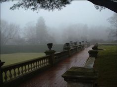 the walkway is lined with urns on either side