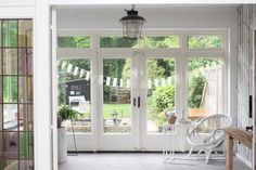 the inside of a house with glass doors and windows on either side of the door