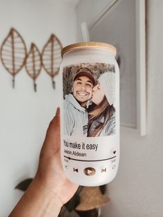 a person holding up a coffee cup with a photo on it