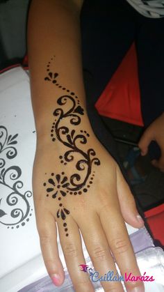 a woman's hand with a henna tattoo on it