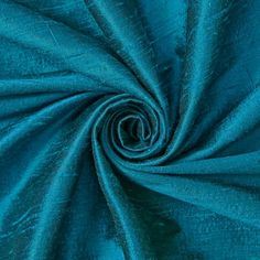 a close up shot of the fabric in teal blue color, with very thin folds