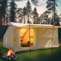 a tent is set up in the middle of a field with a campfire next to it