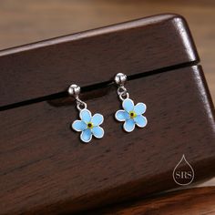 Sterling Silver Enamel Forget-me-not Flower Drop Stud Earrings, Dainty Dangle Forget Me Not Flower Earrings The listing is for a pair of the earrings. Dimensions:  Charm is 8mm.   Stamp: SRS 925 ( SRS is our brand initials for Silver Rain Silver).  Materials: these silver earrings are made with sterling silver and coated with 2 finishes - Rhodium or 18ct yellow gold. Production Method: Small Batch lost wax casting.  ------------------------------------------------------- ♥ Packaging: All our jew Forget Me Not Flower, Lost Wax Casting, Earrings Dainty, Velvet Bag, Forget Me Not, Silver Enamel, Cute Earrings, Flower Earrings, Jewelry Earrings Studs