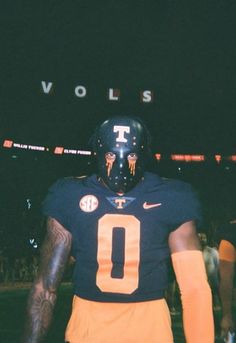 a football player wearing a black and orange uniform