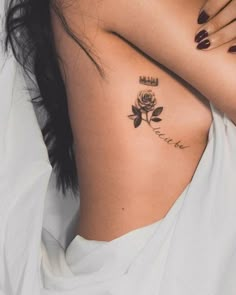 a woman with a rose tattoo on her neck and chest is laying down in bed